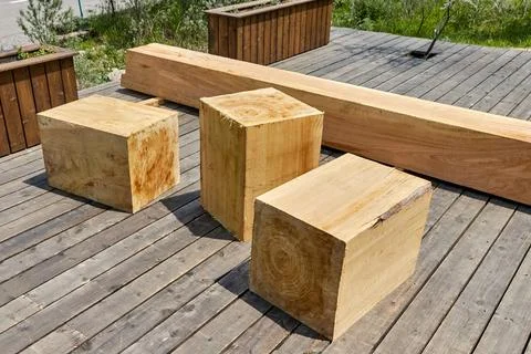 Square bars of the bench made of a single trunk of the Tien Shan spruce Stock Photos
