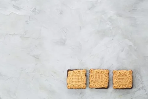 Square biscuits arranged in pattern on light textured background, close-up 스톡 사진