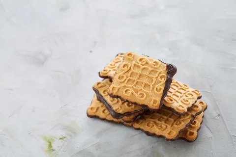 Square biscuits arranged in pattern on light textured background, close-up Stock Photos