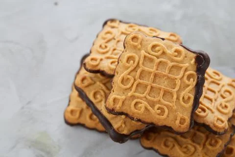 Square biscuits arranged in pattern on light textured background, close-up Stock Photos