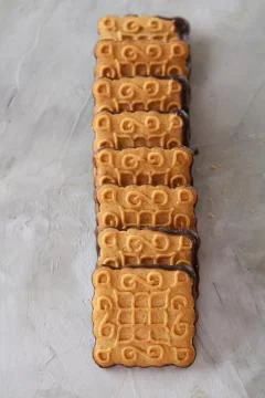 Square biscuits arranged in pattern on light textured background, close-up Stock Photos
