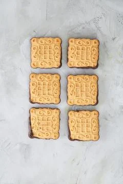 Square biscuits arranged in pattern on light textured background, close-up 스톡 사진