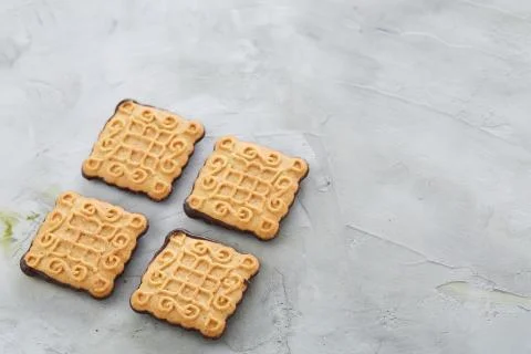 Square biscuits arranged in pattern on light textured background, close-up Stock Photos