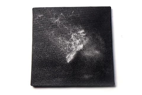 A square black textured tile or canvas isolated on a plain white background.. Stock Photos