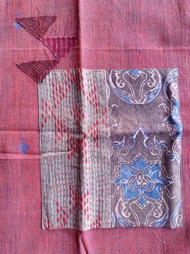 Square blue faded patchwork features three abstract triangle  hand stitching. 스톡 사진