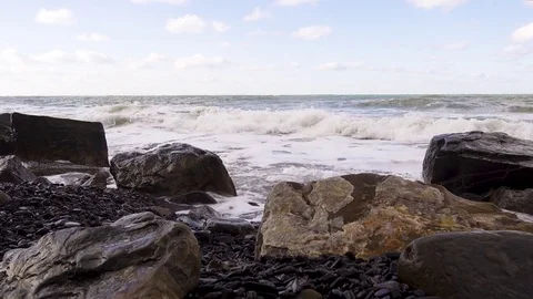 Square boulders on a pebble beach and a storm with sound Stock Footage 82656729