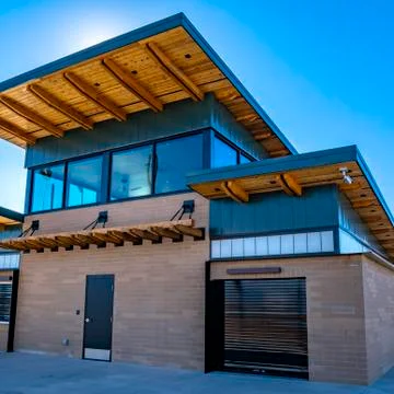 Square Brick building with security camera at a park viewed on a sunny day Fotos de archivo