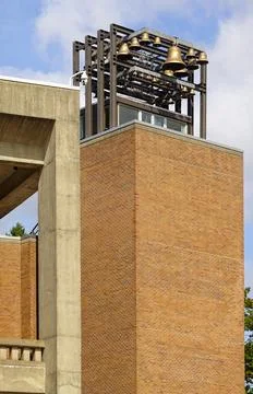 Square brick tower with open bell structure Stock Photos