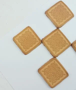 Square butter cookies geometric pattern on white background Stock Photos