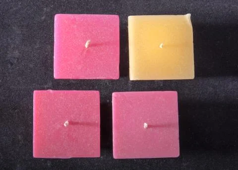 Square candle on a gray background, romantic mood, good night, love. Stock Photos