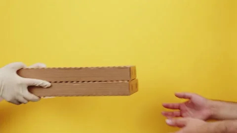 Square cardboard boxes on yellow background. Preparing take away meals. Online Stock Footage 164759928