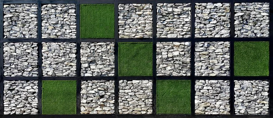 Square check pattern of grass and stone wall Stock Photos