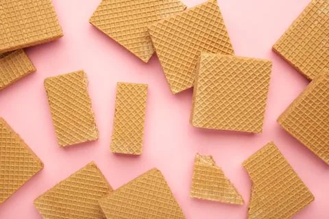 Square chocolate wafer biscuits on pink background. Stock Photos