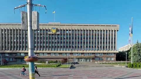 A square of the city, the clear sky, people walking on the sidewalk Stock Footage 131325053
