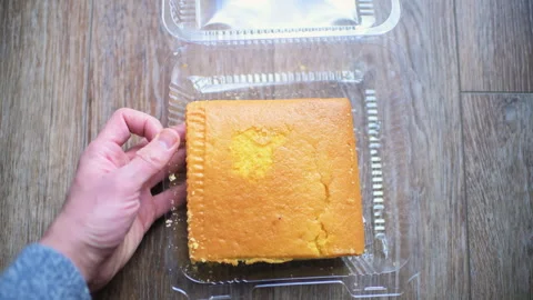 Square cornbread slice in plastic container with sale reduced price label sign Stock Footage 330297233