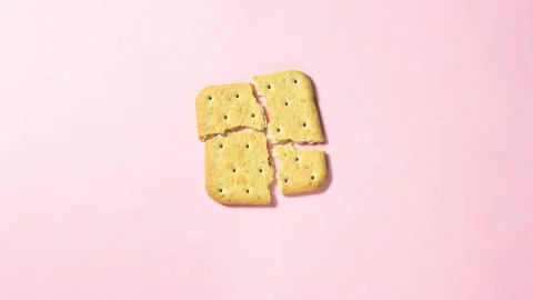 A square cracker that breaks into small pieces Stock Footage 159720675
