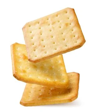 Square crackers falling close-up on a white. Isolated Stock Photos
