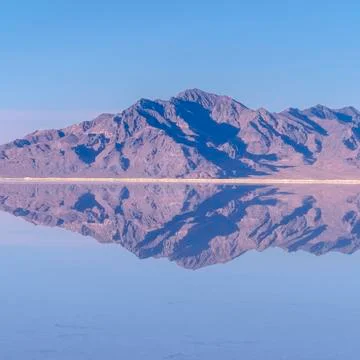 Square crop Mountains reflected as mirror image in still water Stock Photos