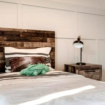 Square crop Single bed with brown wooden headboard and side table with modern Stock-Fotos
