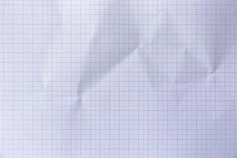 Square crumpled square graph paper on the background. Stock Photos