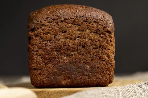 A square dark loaf of bread on the table Foto stock