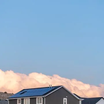 Square Dense white cloud formation behind a house Stock Photos
