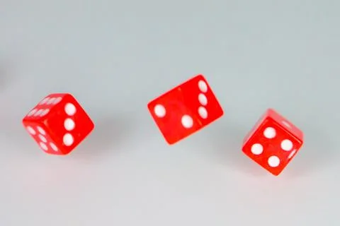 Square dice in red on a white background Stock Photos