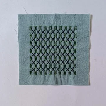 Square Fabric Sample Featuring Sashiko Embroidery.  Stock Photos