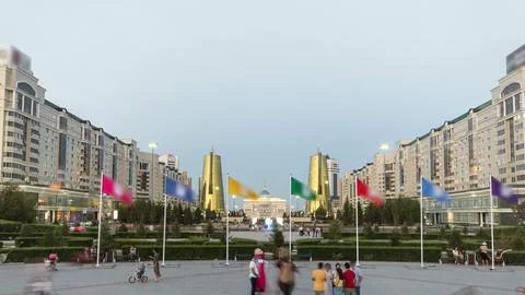 A square with flags in front of Ak Orda with Altyn Orda business center in th Stock Photos