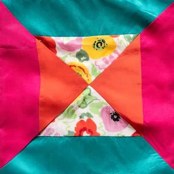 Square fragment of hand-sewn patchwork cloth Stock Photos