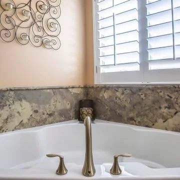 Square frame Bathroom interior with built in bathtub adjacent to the shower Stock Photos