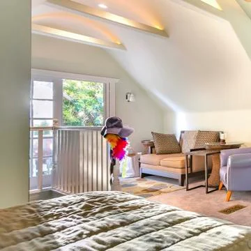 Square frame Bright, open and warm living room with vaulted ceilings, fan and Stock Photos