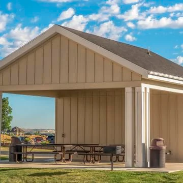 Square frame Building with attached picnic pavilion at a park against mountain Fotos de archivo