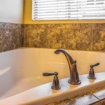 Square frame Close up of the clean white built in bathtun of a bathroom with Foto stock