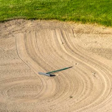 Square frame Close up of golf course sand bunker with a circular pattern created Stock Photos