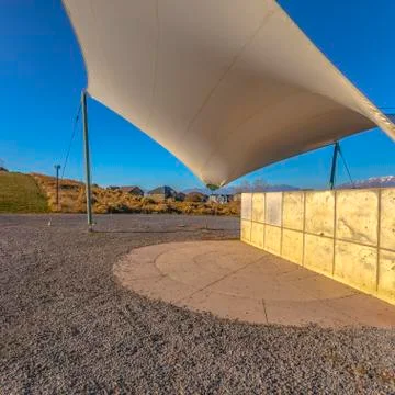 Square frame Concrete rectangular structure on a rocky ground under a white Foto stock