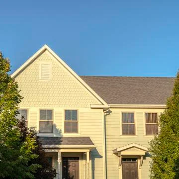 Square frame Facade of a large yellow house in evening light 스톡 사진