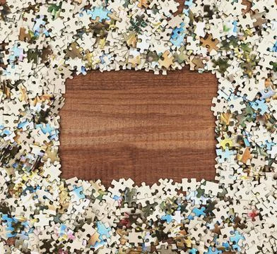 Square frame folded from puzzles on the table. Stock Photos
