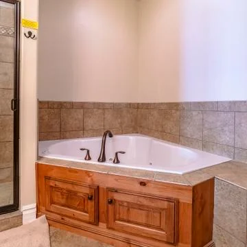 Square frame Interior of a modern bathroom with corner bath Stock Photos