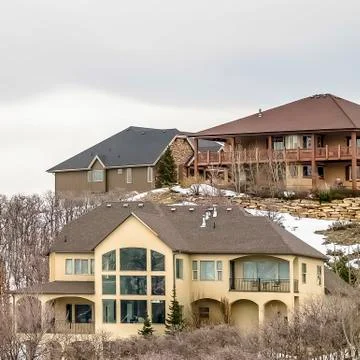 Square frame Luxurious multi storey homes on a snow covered mountain under Stock Photos