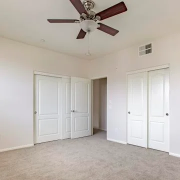 Square frame Master bedroom with view into bathroom 스톡 사진