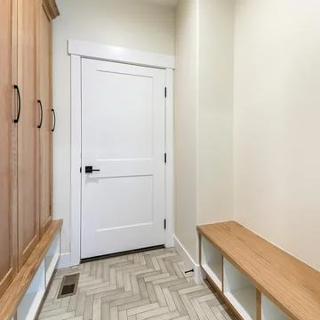Square frame Mudroom interior with herringbone tile pattern flooring and wooden Stock Photos