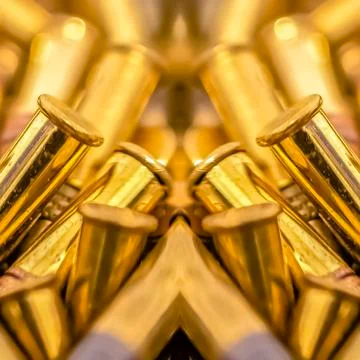 Square frame Pile of shiny bullets on an axis of symmetry 写真素材