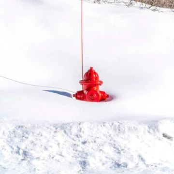 Square frame Red fire hydrant on a snow covered mountain in Park City Utah in Foto stock