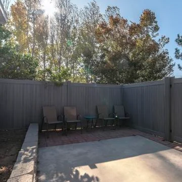 Square frame Small enclosed yard with high fence and gate Stock Photos