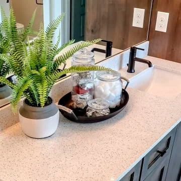 Square frame Two sinks on white countertop with plant beside tray of cotton and Foto stock