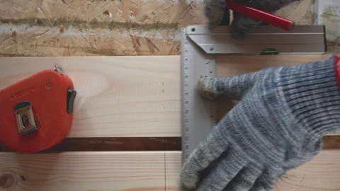Square frame is used to mark a wooden board with a pencil Stock Footage 147245800