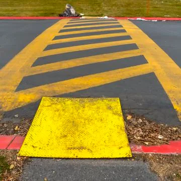 Square frame Yellow diagonal stripes between parallel lines painted on a paved Fotos Stock