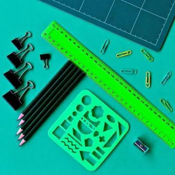 Square green school items flatlay. Stock Photos