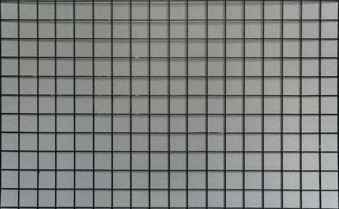Square grid pattern with grey tiles, creating a clean, geometric texture. Stock Photos